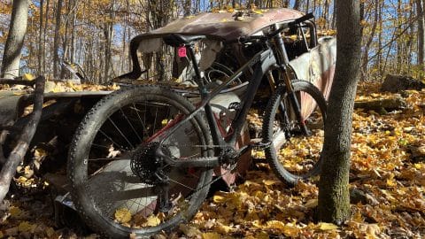Mtb Bike leaning again old, worn down truck on Vermont bike trail.