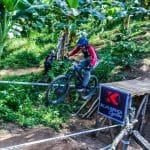 Enduro racer going off jump in race.