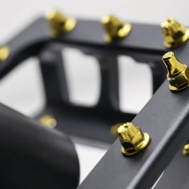 Close up of Gold Shortie & K9 Traction Pin installed on a Blackjack Black REMtech Pedal.