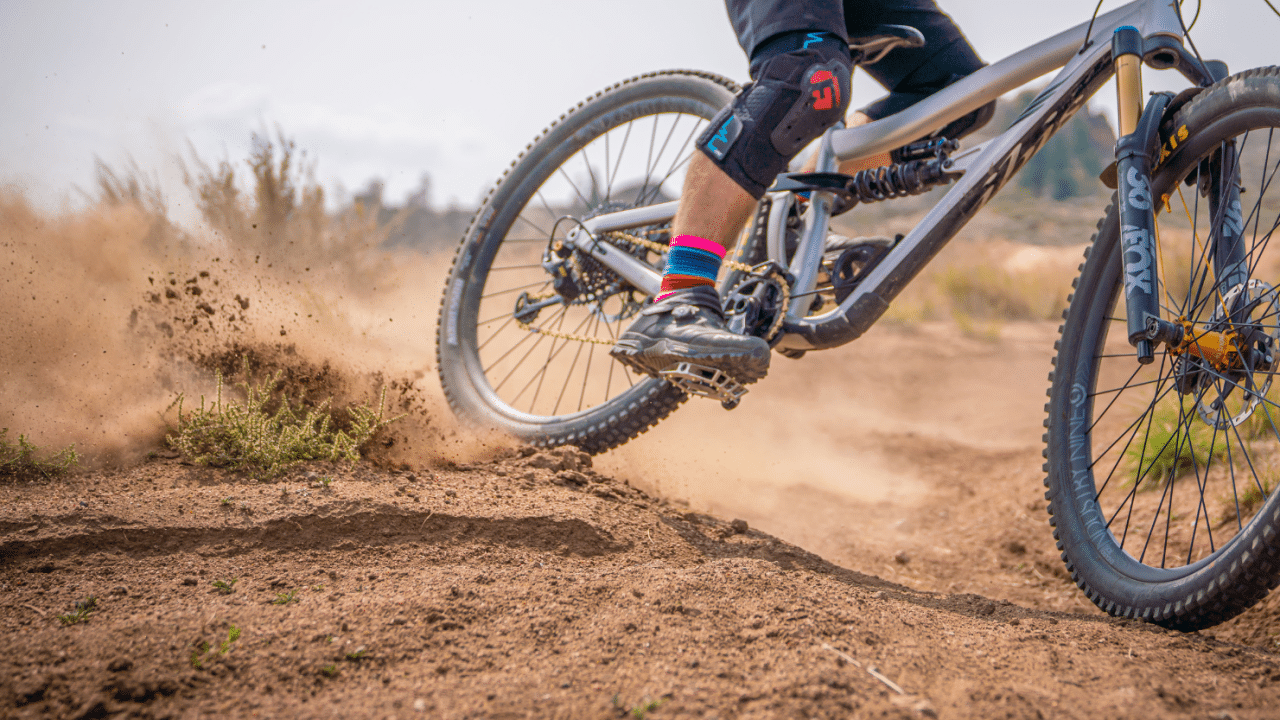 Close up of SpicyTy sliding on his mountain bike. The main focus is his shoe on the REMtech pedal.
