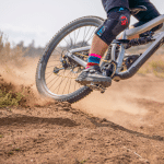 Close up of SpicyTy sliding on his mountain bike. The main focus is his shoe on the REMtech pedal.