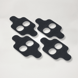 4 black shoe shims laid on a light gray background.