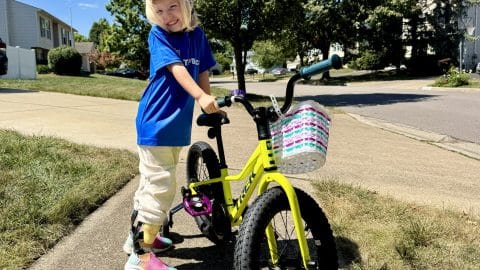Young amputee bike rider about to independently ride with her magnetic pedals.