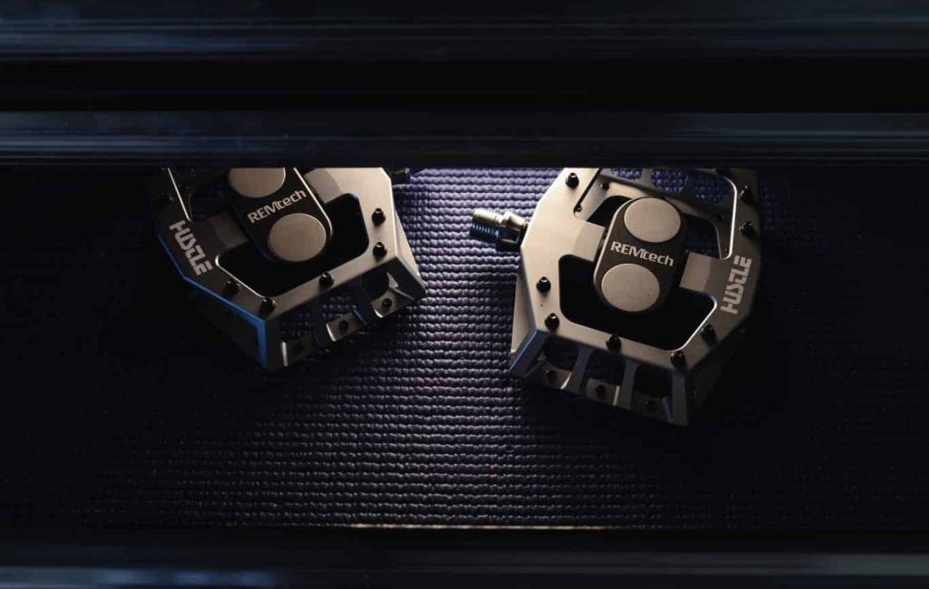 Gunmetal Gray REMtech Magnetic Pedals being pulled out from a black toolbox.